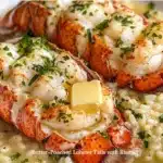 Delicious butter-poached lobster tails with creamy risotto on a plate.