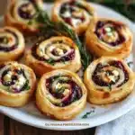 A plate of delicious cranberry feta pinwheels ready to be served.