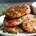 Delicious homemade tuna patties served on a plate with garnish.